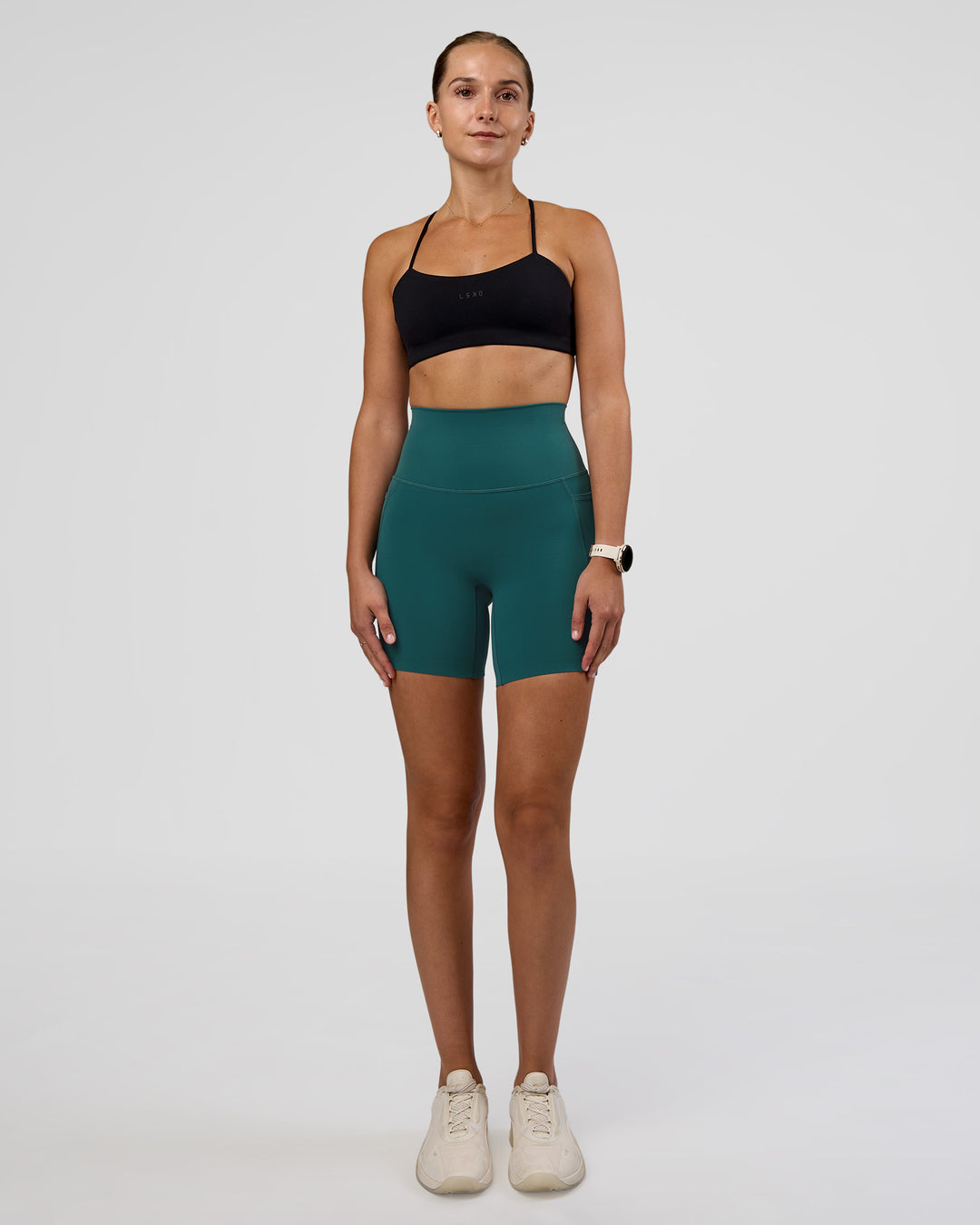 Woman wearing Elixir Ultra High-Rise 6" Short Pockets - Transformative Teal | Model:Myrte | Size:S