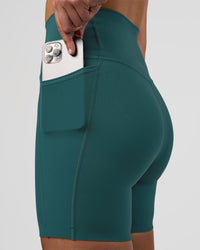 Woman wearing Elixir Ultra High-Rise 6" Short Pockets - Transformative Teal | Model:Myrte | Size:S