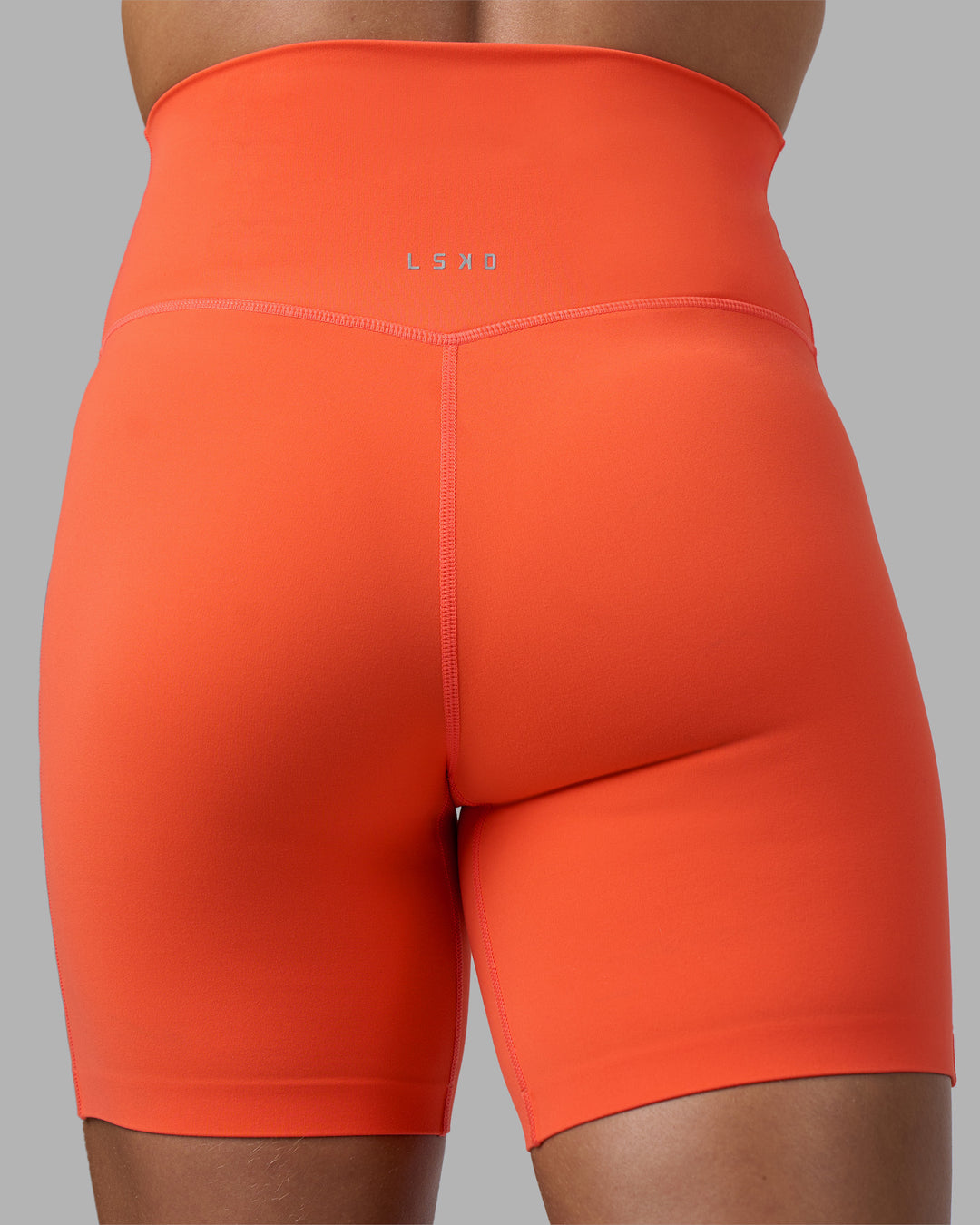 Woman wearing Elixir Ultra High-Rise 6&quot; Short - Ultra Orange | Model:Katie | Size:S