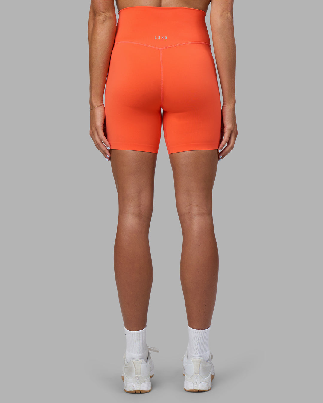 Woman wearing Elixir Ultra High-Rise 6&quot; Short - Ultra Orange | Model:Katie | Size:S