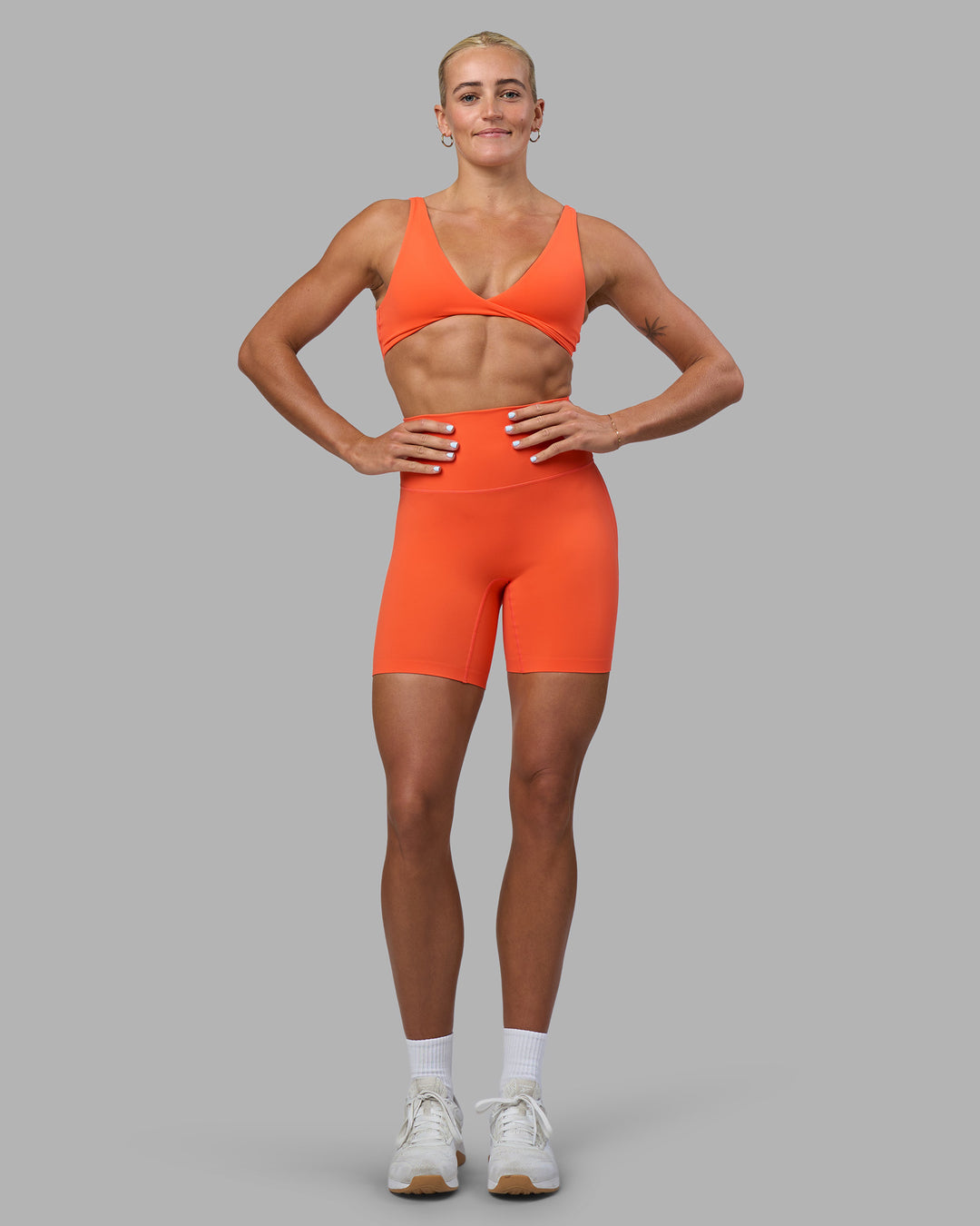 Woman wearing Elixir Ultra High-Rise 6&quot; Short - Ultra Orange | Model:Katie | Size:S