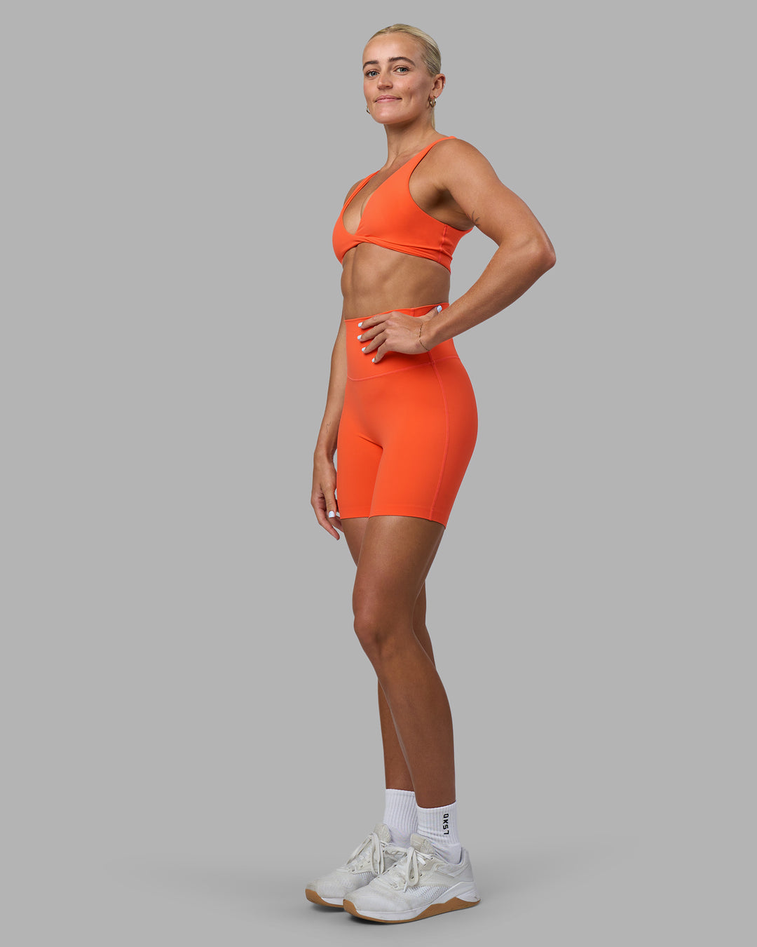 Woman wearing Elixir Ultra High-Rise 6&quot; Short - Ultra Orange | Model:Katie | Size:S