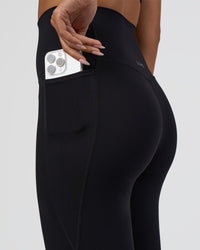 Woman wearing Elixir Ultra High-Rise 7/8 Legging Pockets - Black | Model:Ruby | Size:S
