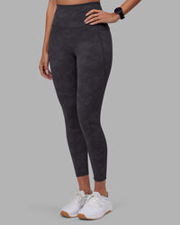 Woman wearing Elixir Ultra High-Rise 7/8 Legging Pockets - Dark Storm Wash | Model:Rhiley | Size:S