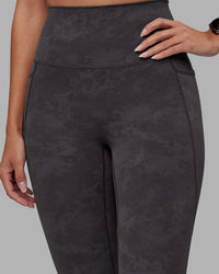 Woman wearing Elixir Ultra High-Rise 7/8 Legging Pockets - Dark Storm Wash | Model:Rhiley | Size:S