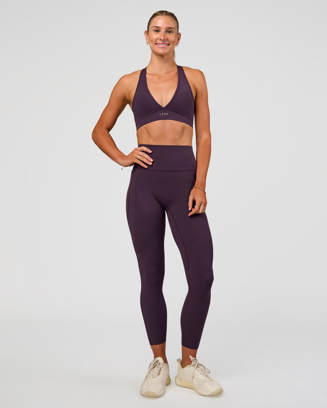 Woman wearing Elixir Ultra High-Rise 7/8 Legging Pockets - Midnight Plum | Model:Emelia | Size:S