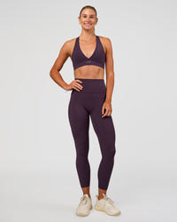 Woman wearing Elixir Ultra High-Rise 7/8 Legging Pockets - Midnight Plum | Model:Emelia | Size:S