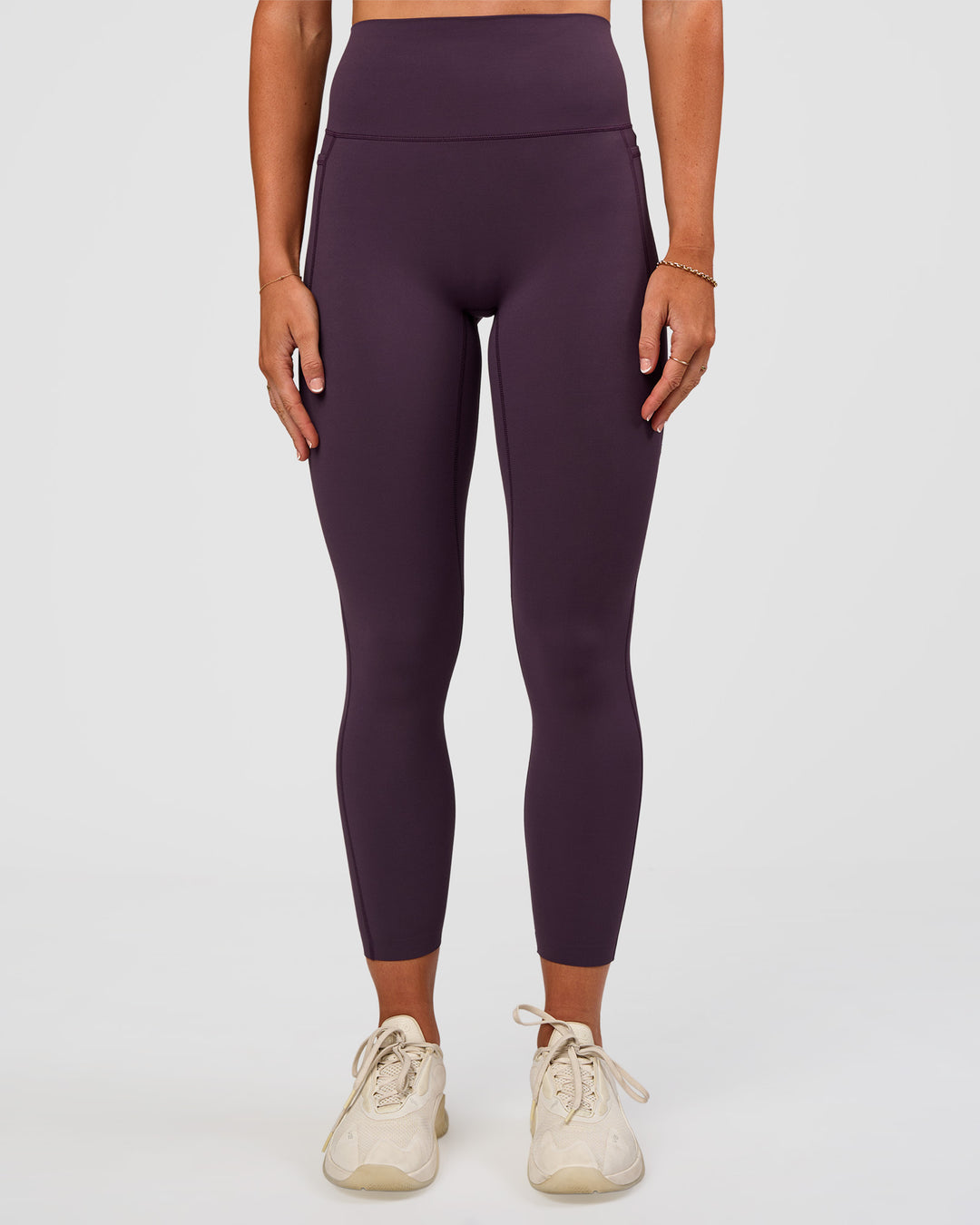 Woman wearing Elixir Ultra High-Rise 7/8 Legging Pockets - Midnight Plum | Model:Emelia | Size:S