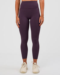 Woman wearing Elixir Ultra High-Rise 7/8 Legging Pockets - Midnight Plum | Model:Emelia | Size:S