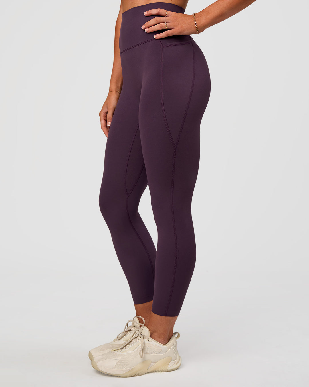 Woman wearing Elixir Ultra High-Rise 7/8 Legging Pockets - Midnight Plum | Model:Emelia | Size:S