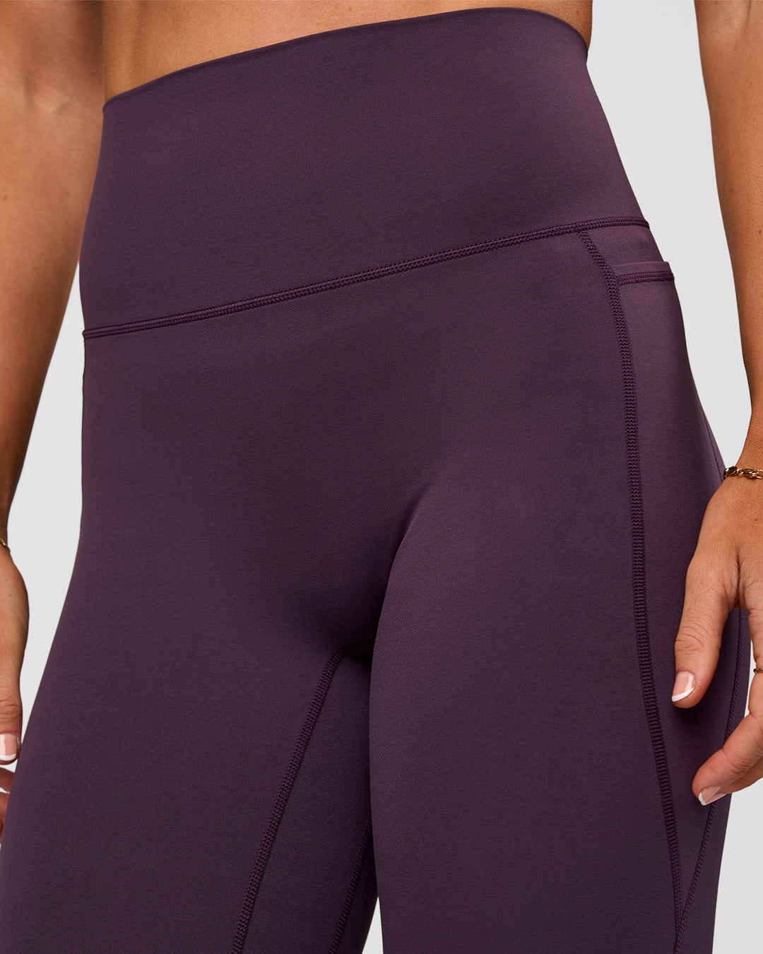 Woman wearing Elixir Ultra High-Rise 7/8 Legging Pockets - Midnight Plum | Model:Emelia | Size:S