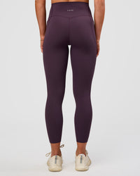 Woman wearing Elixir Ultra High-Rise 7/8 Legging Pockets - Midnight Plum | Model:Emelia | Size:S