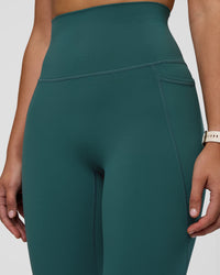 Woman wearing Elixir Ultra High-Rise 7/8 Legging Pockets - Transformative Teal | Model:Myrte | Size:S