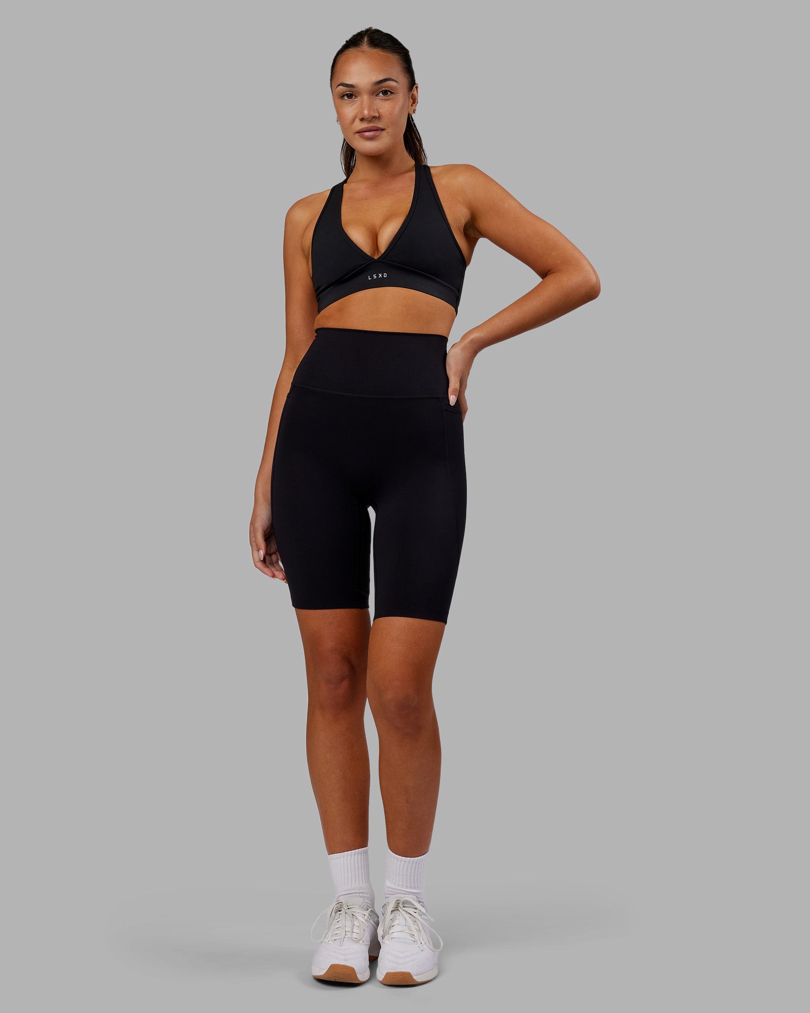 Woman wearing Elixir Ultra High-Rise 9" Short Pockets - Black | Model:Kirstyn | Size:S