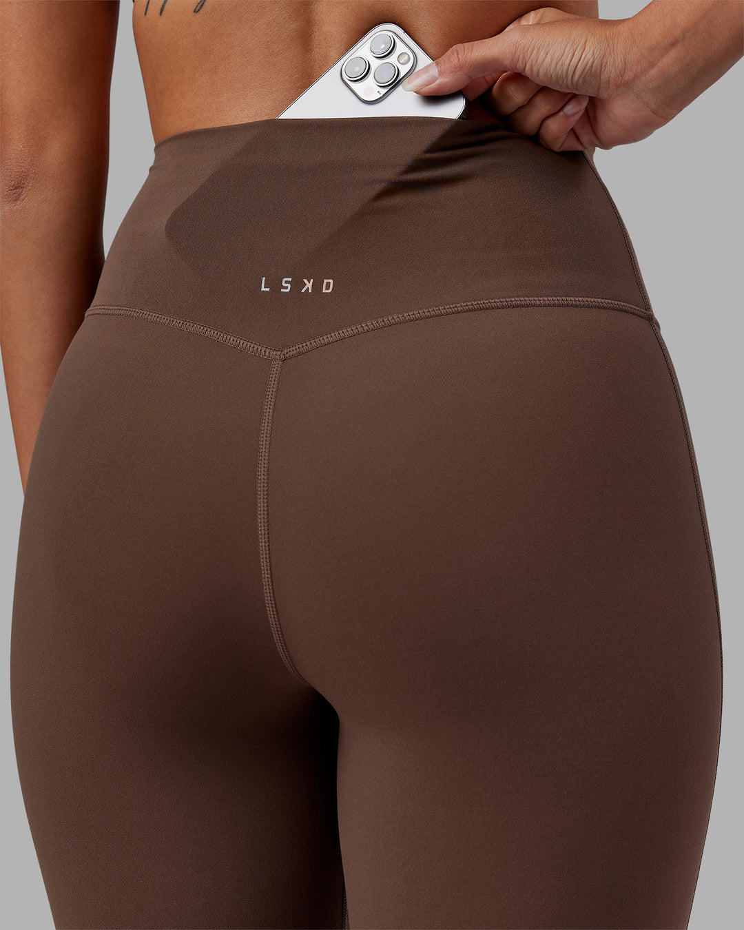 Woman wearing Elixir Ultra High-Rise Full Length Legging - Chocolate Martini | Model:Rhiley | Size:S