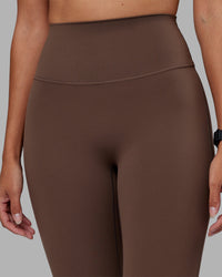 Woman wearing Elixir Ultra High-Rise Full Length Legging - Chocolate Martini | Model:Rhiley | Size:S