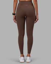 Woman wearing Elixir Ultra High-Rise Full Length Legging - Chocolate Martini | Model:Rhiley | Size:S