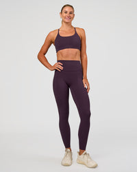 Woman wearing Elixir Ultra High-Rise Full Length Legging Pockets - Midnight Plum | Model:Emelia | Size:S