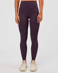 Woman wearing Elixir Ultra High-Rise Full Length Legging Pockets - Midnight Plum | Model:Emelia | Size:S