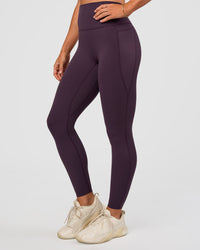 Woman wearing Elixir Ultra High-Rise Full Length Legging Pockets - Midnight Plum | Model:Emelia | Size:S