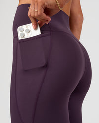 Woman wearing Elixir Ultra High-Rise Full Length Legging Pockets - Midnight Plum | Model:Emelia | Size:S