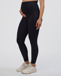 Woman wearing Elixir Ultra High-Rise Maternity Full Length Legging Pockets - Black | Model:Kitahna | Size:S