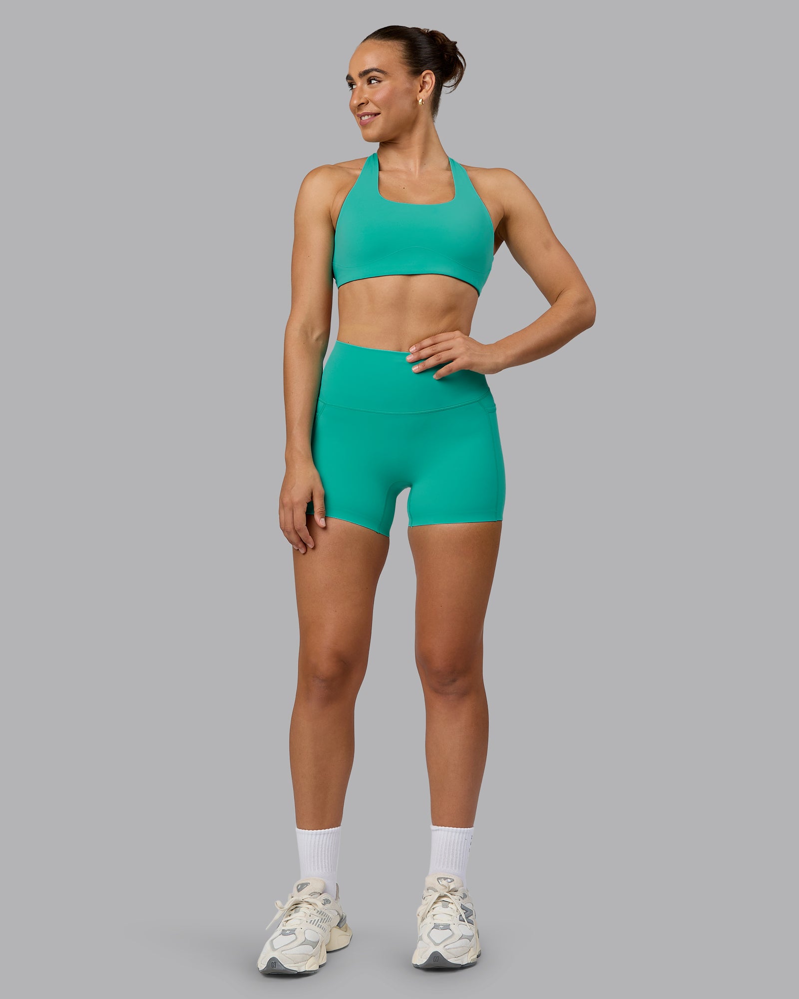 Woman wearing Elixir Ultra High-Rise 4" Short Pockets - Atlantis | Model:Sophie | Size:S