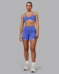 Woman wearing Elixir Ultra High-Rise 4" Short Pockets - Baja Blue | Model:Sophie | Size:S