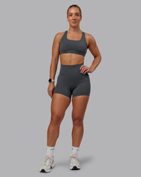 Woman wearing Elixir Ultra High-Rise 4" Short Pockets - Dark Storm | Model:Lyss | Size:S