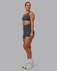 Woman wearing Elixir Ultra High-Rise 4" Short Pockets - Dark Storm | Model:Lyss | Size:S