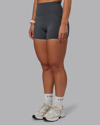 Woman wearing Elixir Ultra High-Rise 4" Short Pockets - Dark Storm | Model:Lyss | Size:S