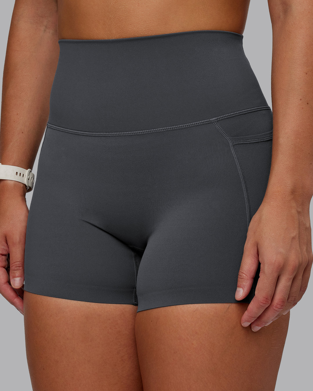 Woman wearing Elixir Ultra High-Rise 4&quot; Short Pockets - Dark Storm | Model:Lyss | Size:S