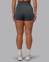Woman wearing Elixir Ultra High-Rise 4" Short Pockets - Dark Storm | Model:Lyss | Size:S