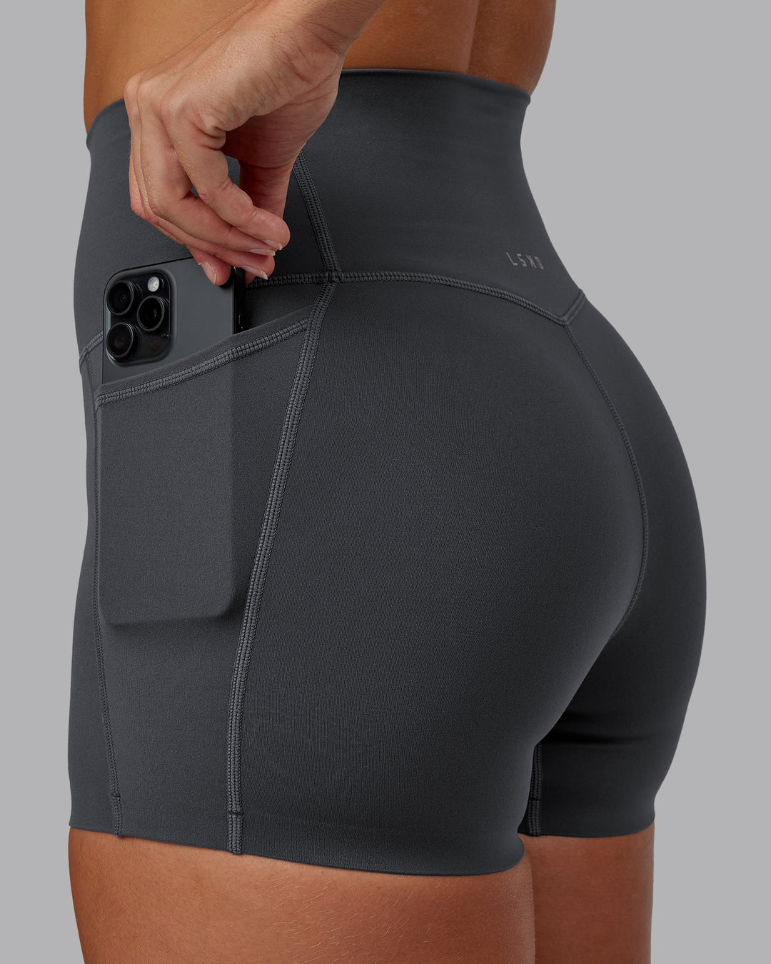 Woman wearing Elixir Ultra High-Rise 4&quot; Short Pockets - Dark Storm | Model:Lyss | Size:S