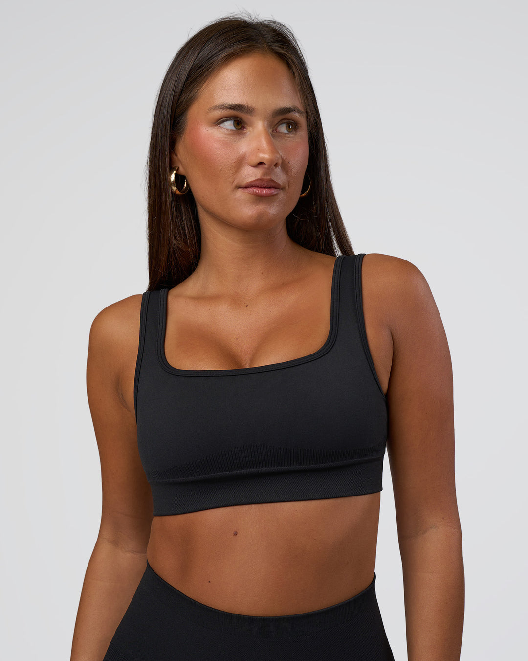 Woman wearing Ember Seamless Sports Bra - Black | Model:Brylee | Size:XS