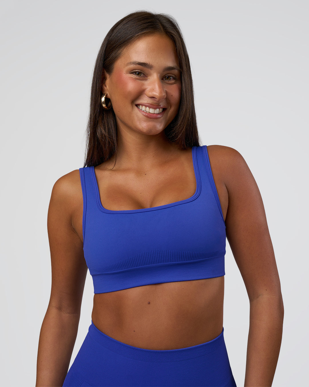 Woman wearing Ember Seamless Sports Bra - Power Cobalt | Model:Bianca | Size:S