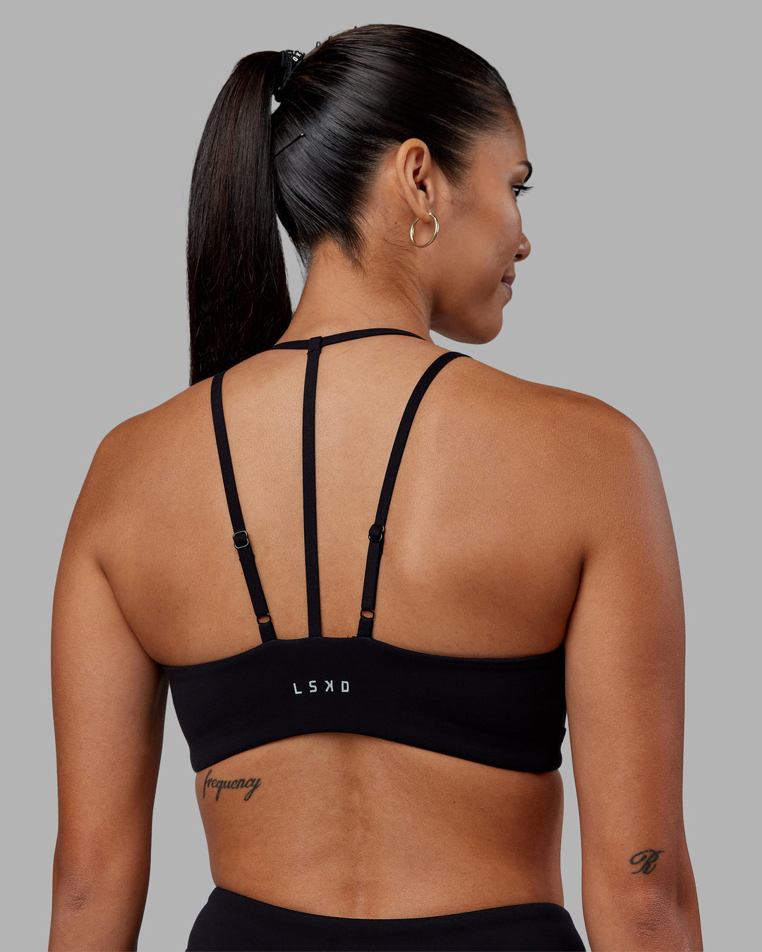 Woman wearing Empower Sports Bra - Black | Model:Rhiley | Size:S