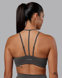 Woman wearing Empower Sports Bra - Dark Storm | Model:Rhiley | Size:S