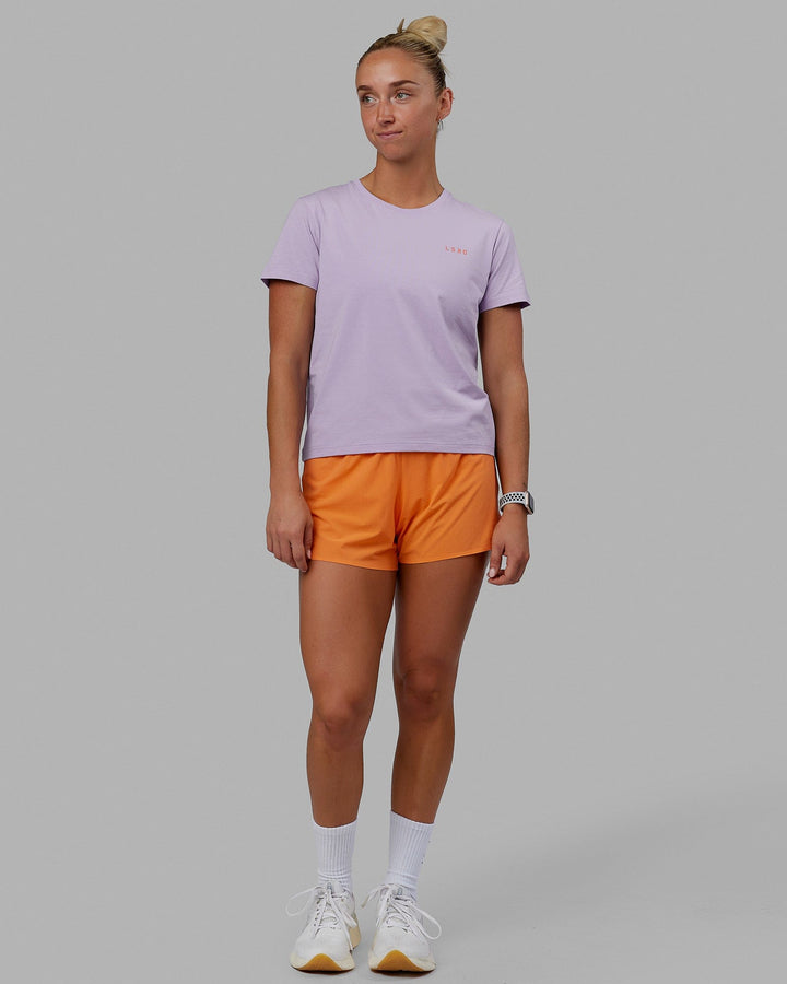 Woman wearing Endeavour FLX Cotton Tee - Pale Lilac-Impact Orange