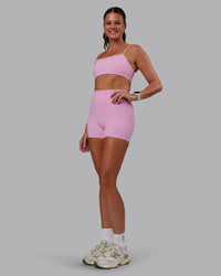 Woman wearing Enhance Ultra High-Rise 4" Short - Pink Frosting | Model:Phoebe | Size:S