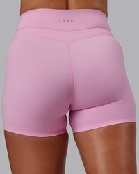 Woman wearing Enhance Ultra High-Rise 4" Short - Pink Frosting | Model:Phoebe | Size:S