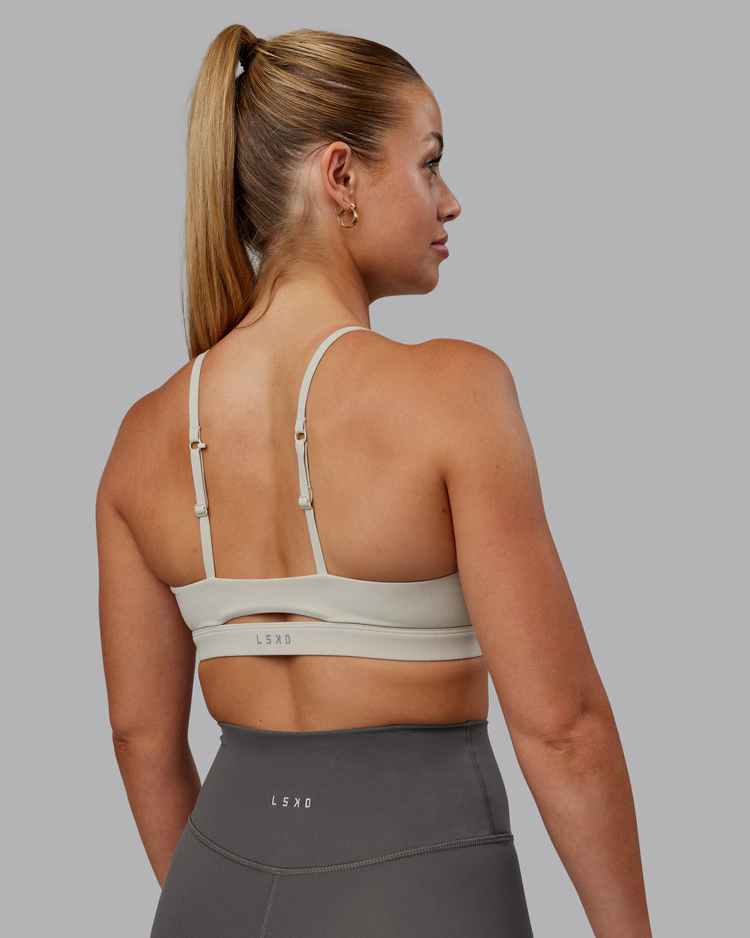 Woman wearing Essence Sports Bra - Shale Beige | Model:Hannah | Size:S