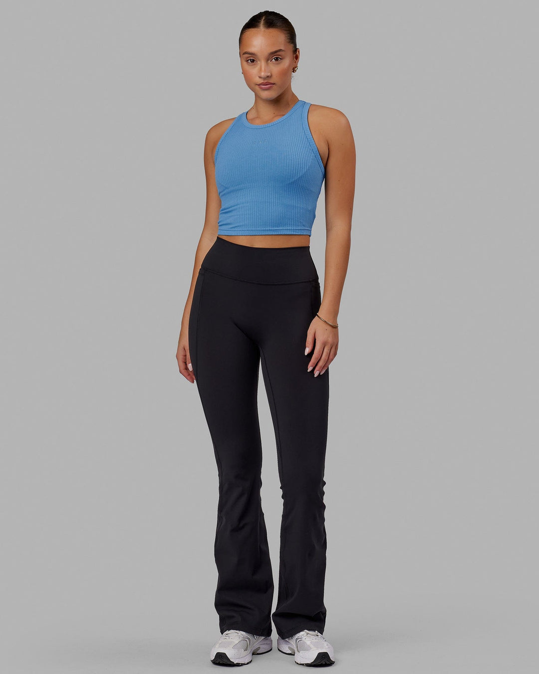 Woman wearing Fusion Ultra High-Rise Flared Legging Pockets - Black | Model:Milly | Size:S