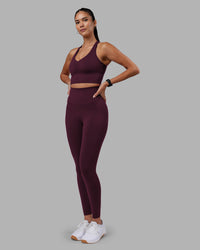 Woman wearing Evoke Longline Sports Bra - Cherry Lacquer | Model:Rhiley | Size:S