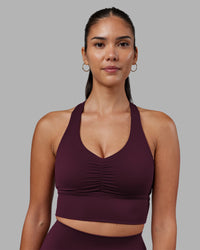 Woman wearing Evoke Longline Sports Bra - Cherry Lacquer | Model:Rhiley | Size:S