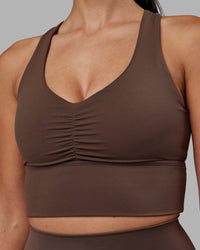 Woman wearing Evoke Longline Sports Bra - Chocolate Martini | Model:Rhiley | Size:S