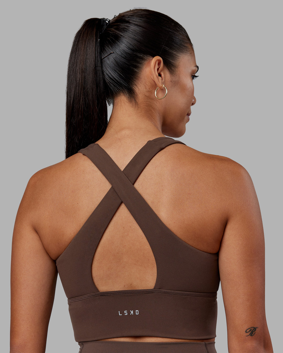 Woman wearing Evoke Longline Sports Bra - Chocolate Martini | Model:Rhiley | Size:S