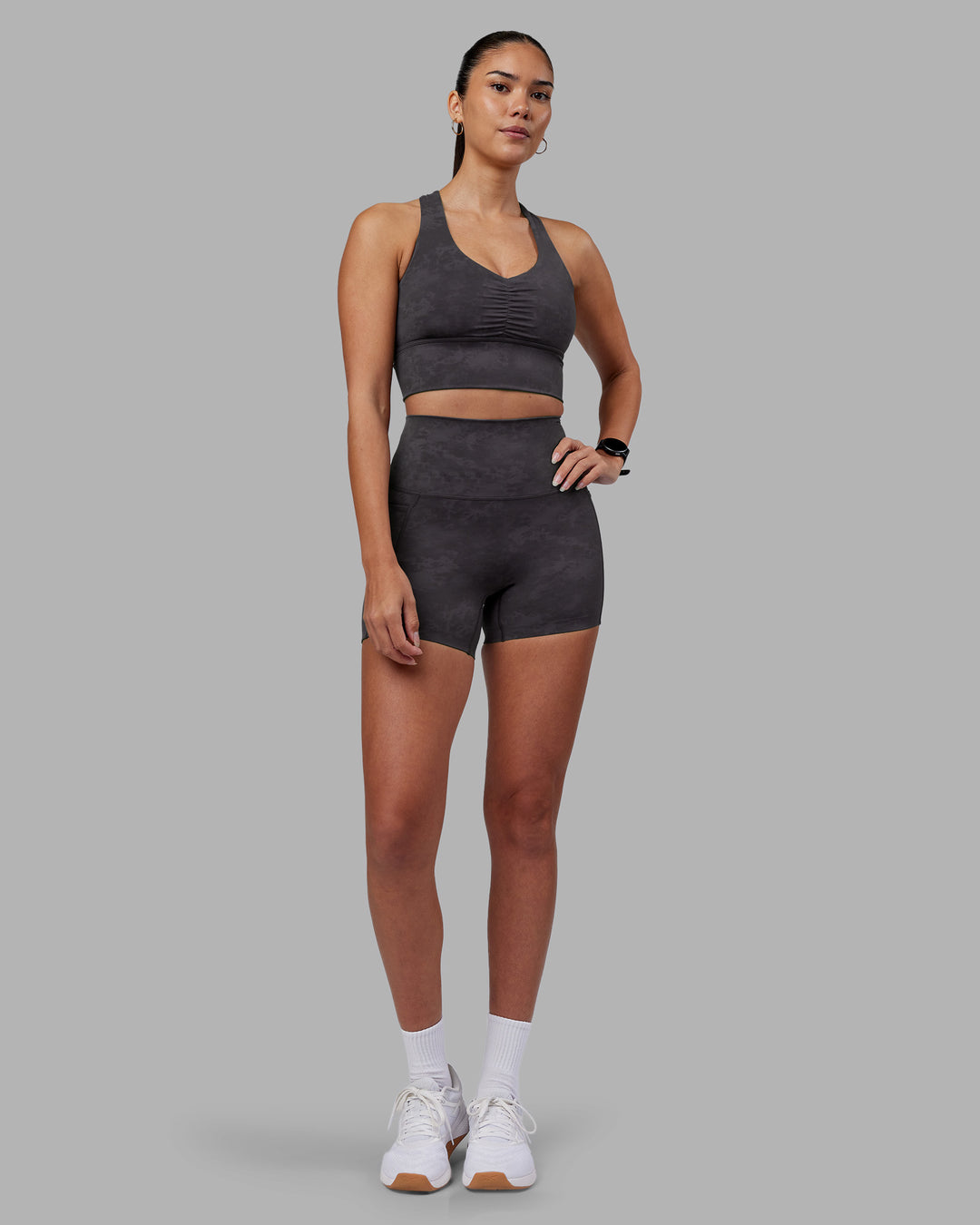 Woman wearing Evoke Longline Sports Bra - Dark Storm Wash | Model:Rhiley | Size:S