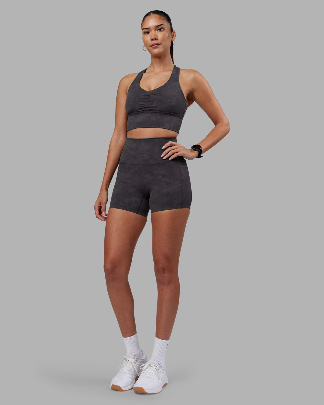 Woman wearing Evoke Longline Sports Bra - Dark Storm Wash | Model:Rhiley | Size:S