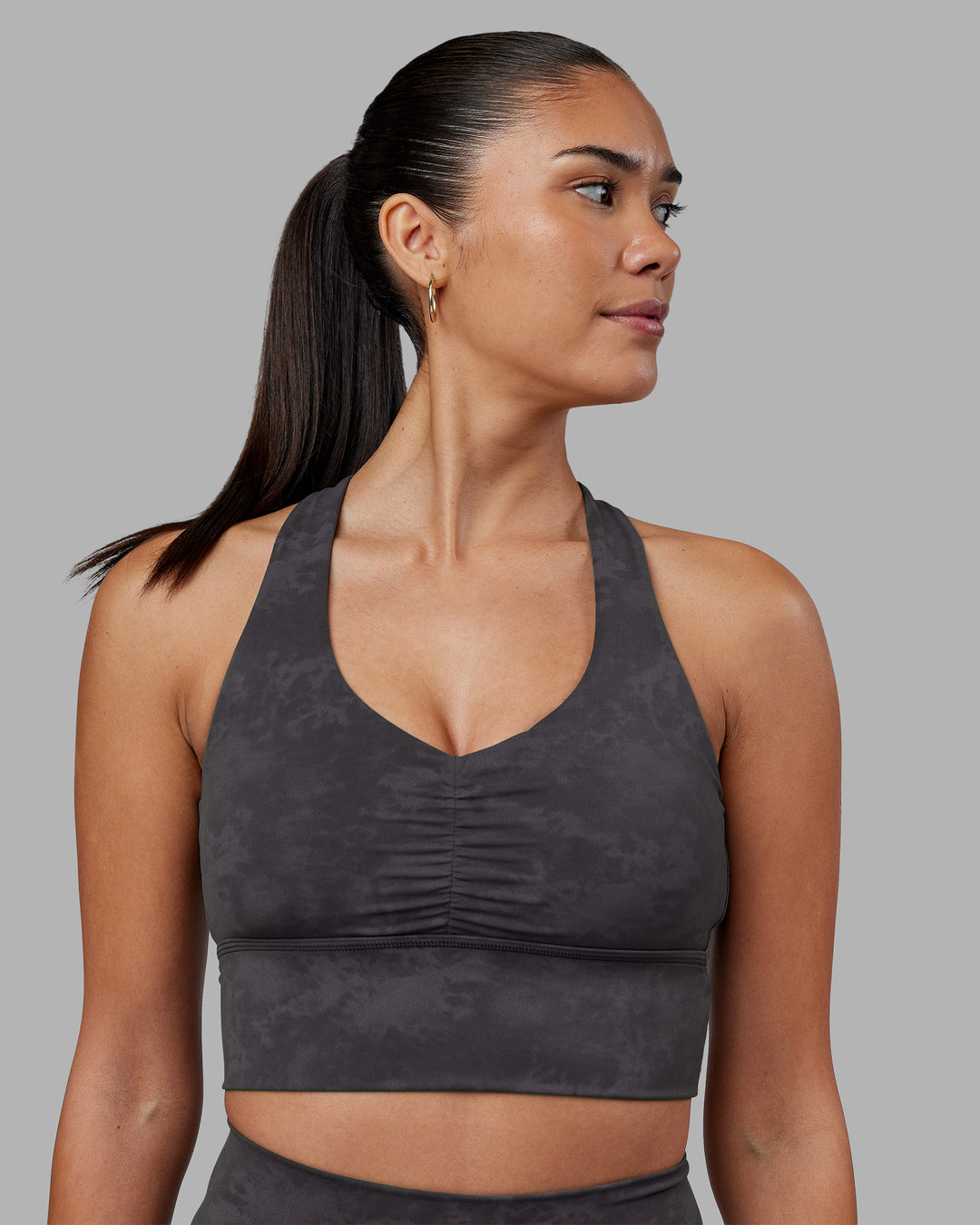 Woman wearing Evoke Longline Sports Bra - Dark Storm Wash | Model:Rhiley | Size:S